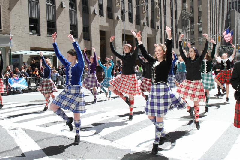 Dancers clad in Scottish kilts march in New York City Tartan Day Parade